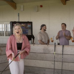 laughing women on driving range with friends