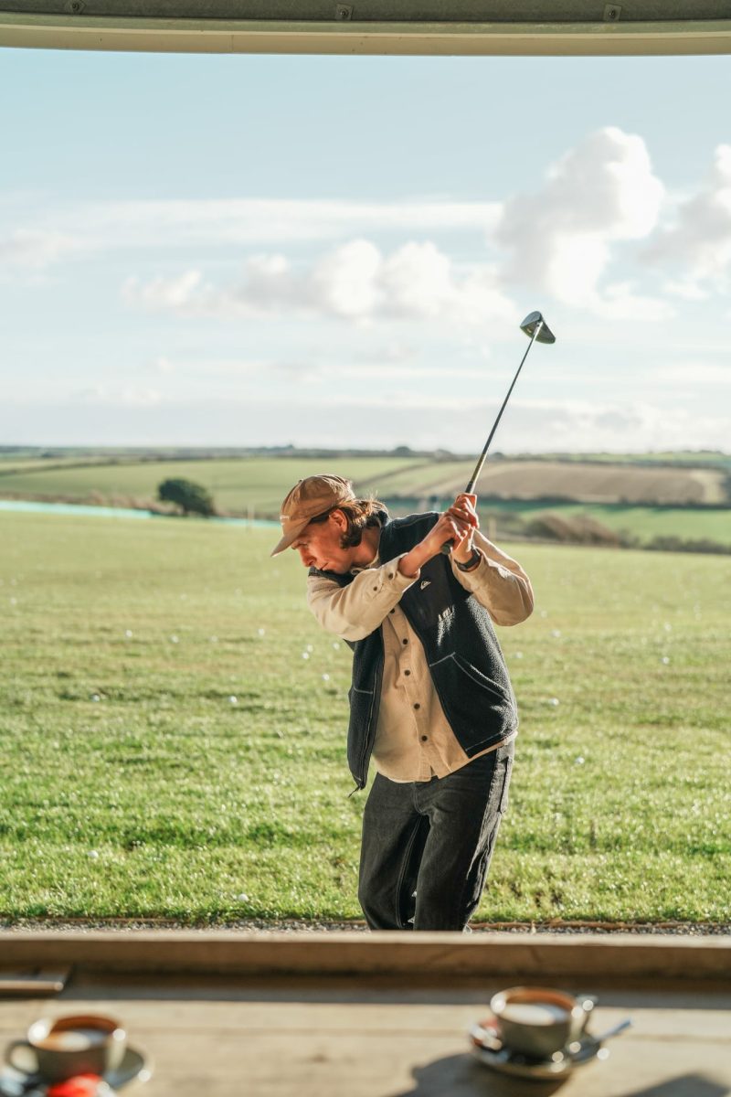 Man playing golf on the driving range at Halwyn