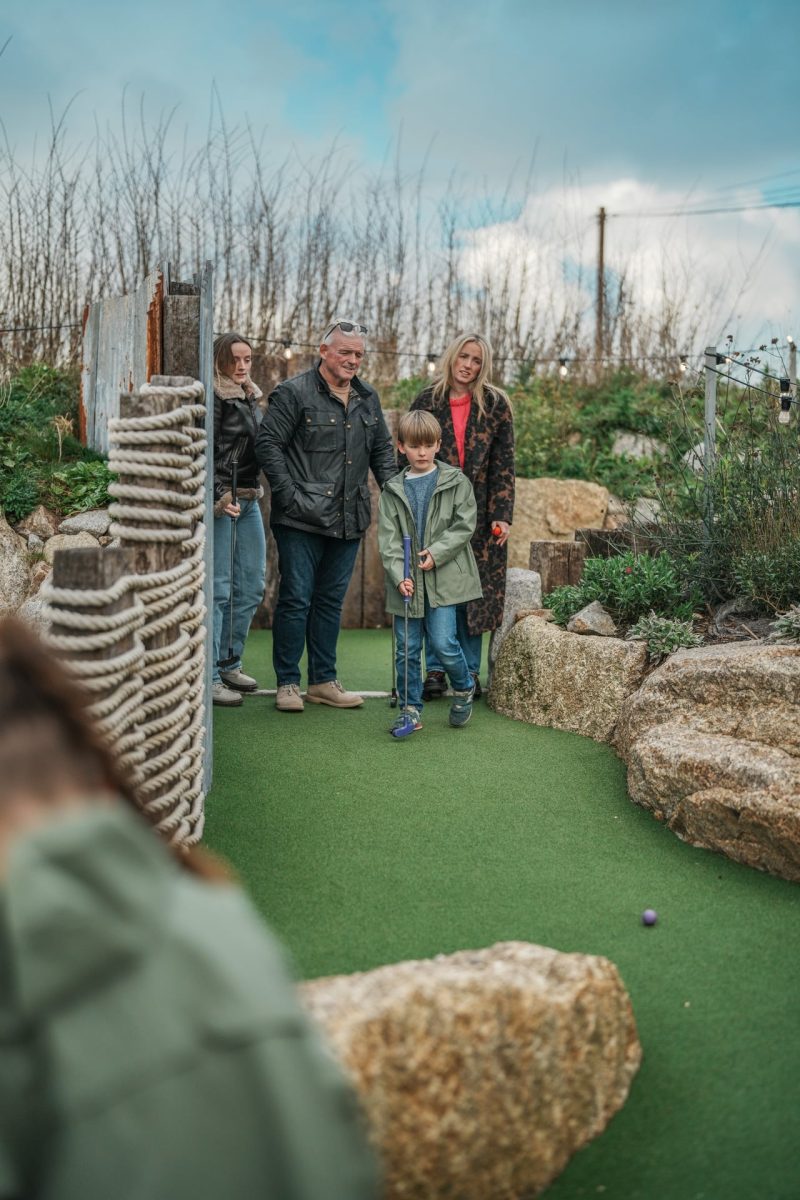 Family playing minigolf