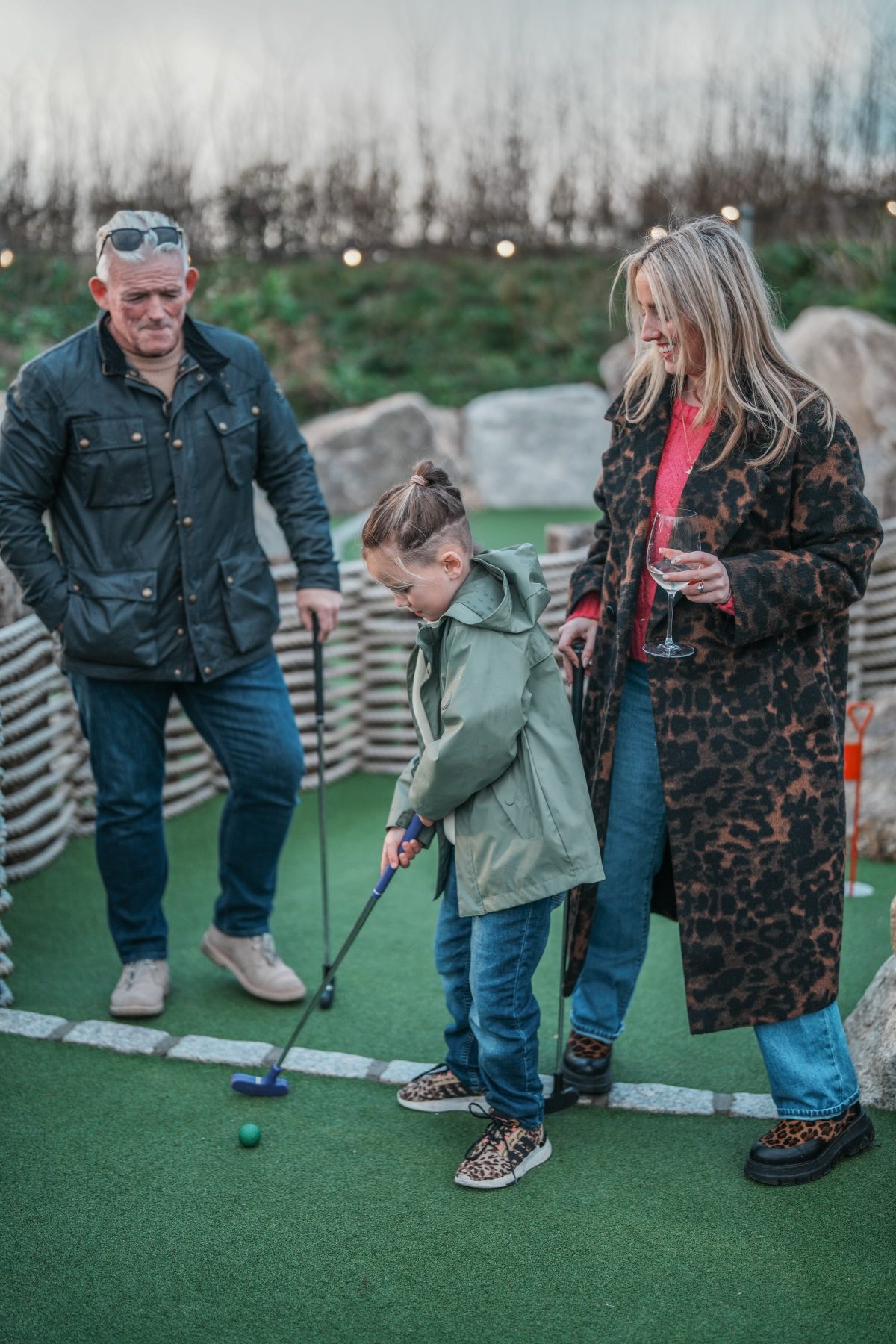 Family playing golf