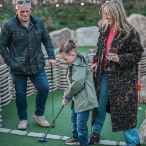 Family playing golf