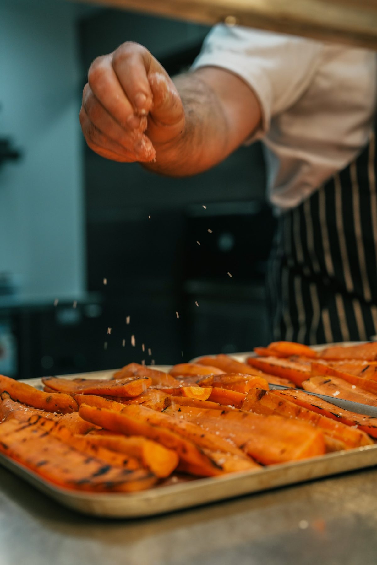 Carrots being seasoned