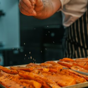 Carrots being seasoned