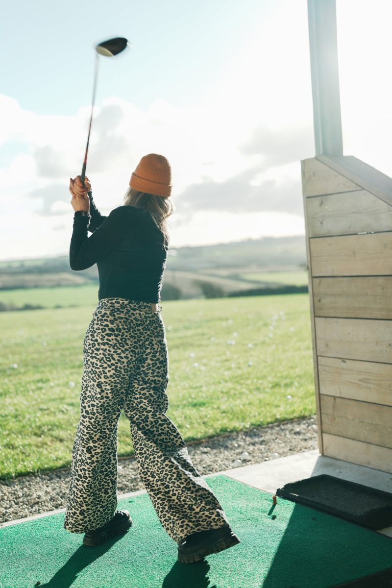 Women playing golf on the driving rage