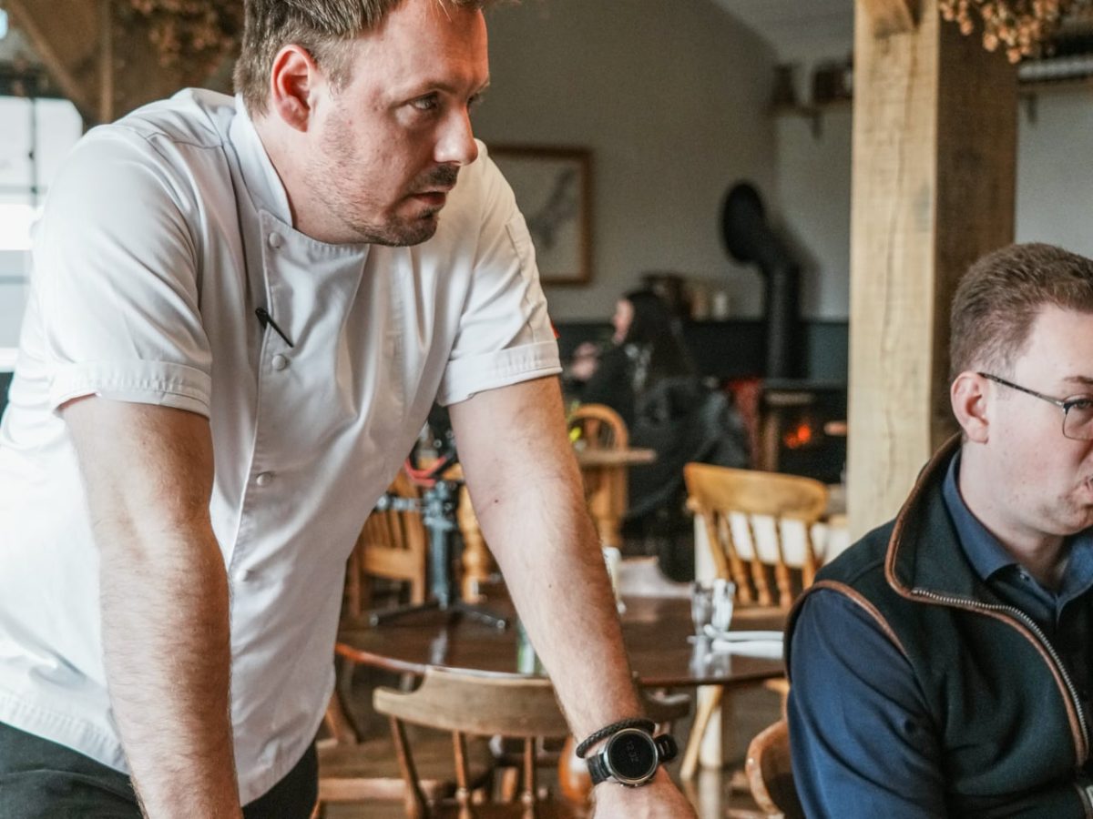 Chef leaning on table