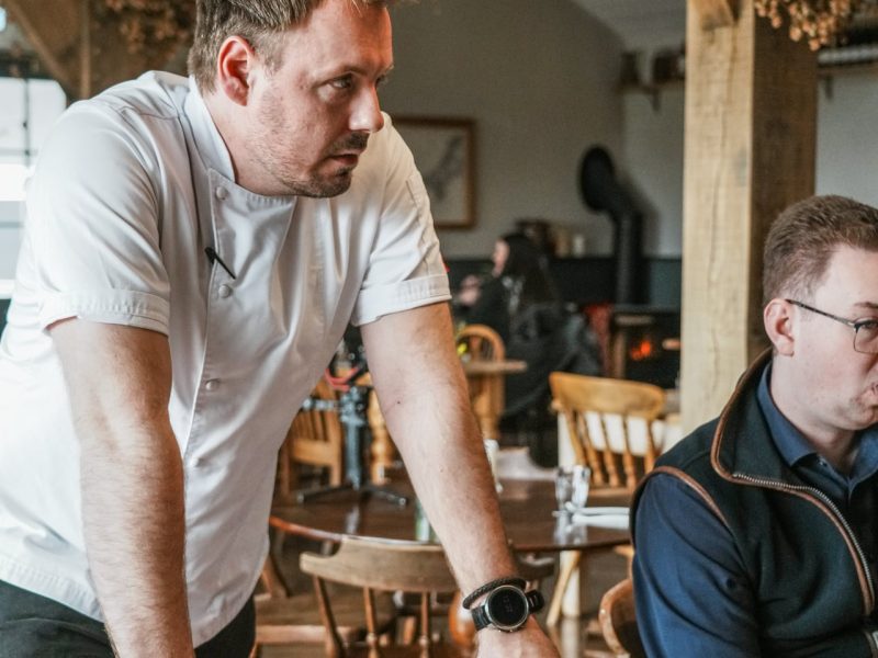 Chef leaning on table