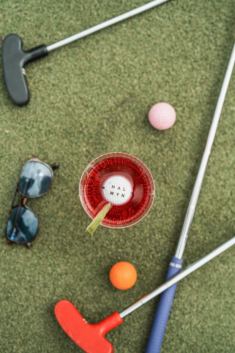 Golf balls and clubs on the grass