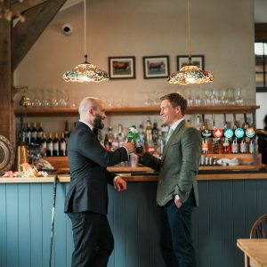 Two men stood at bar