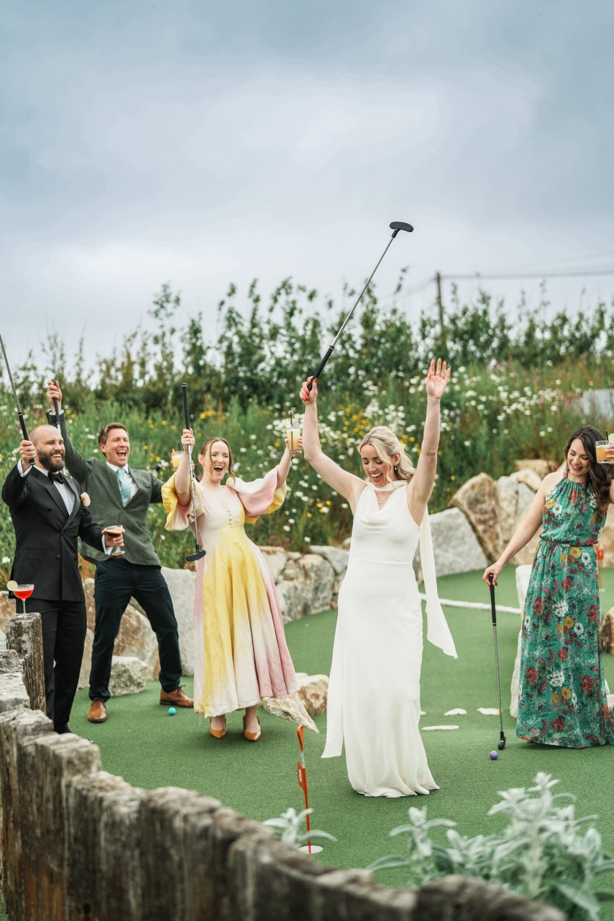 People raising glasses on mini golf