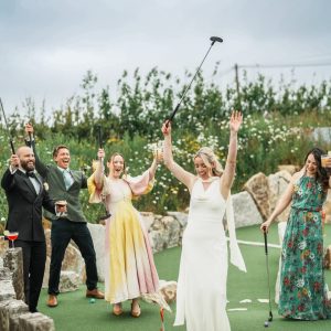 People raising glasses on mini golf