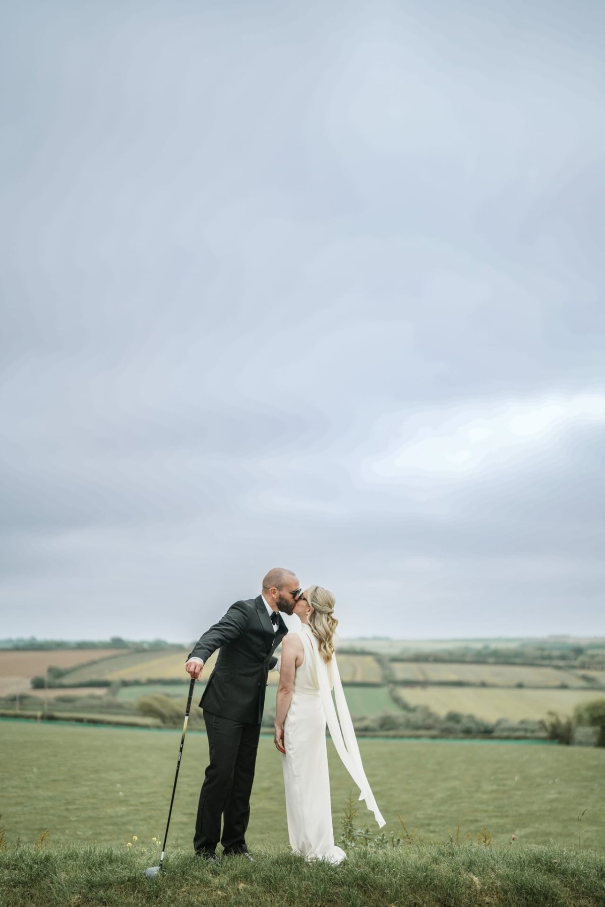 Bride and groom in field