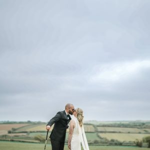 Bride and groom in field